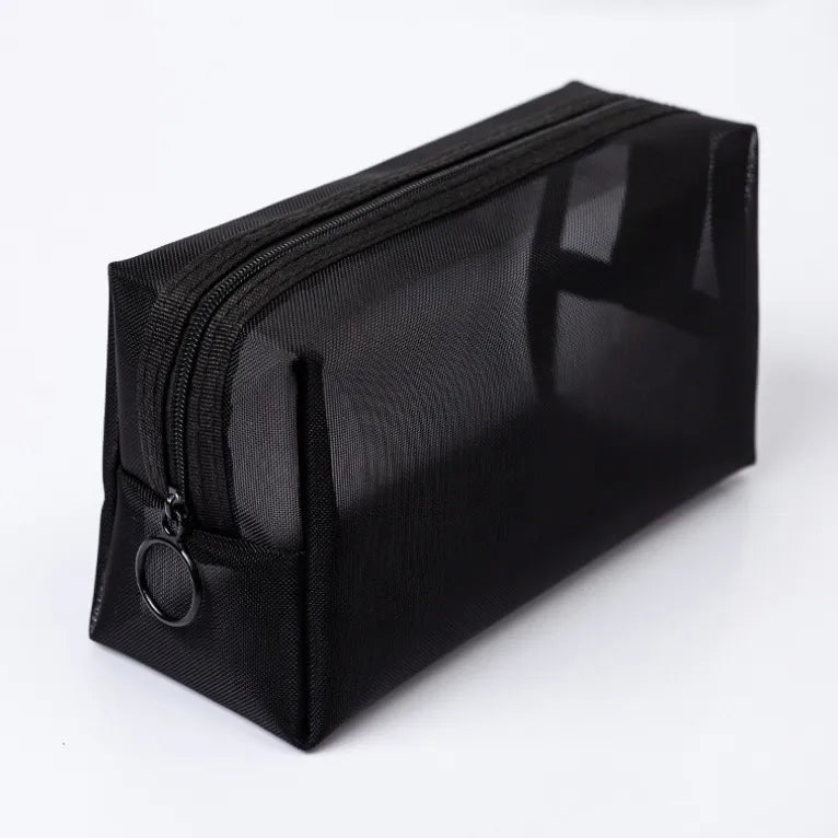 Black rectangular mesh toiletry pouch, closed, with zip fastening and ring pull